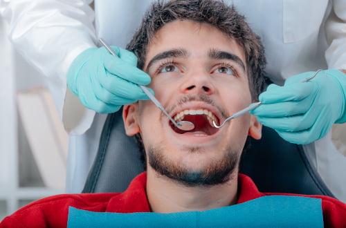 Dentist performing a professional teeth whitening procedure for a patient in a dental clinic in Vaughan