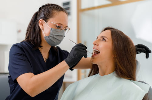 Dentist performing a dental check-up for a patient at Mapleridge Dentistry in Vaughan under the Canadian Dental Care Plan (CDCP)