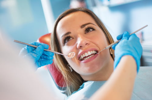 Dentist examining a patient’s teeth during a dental visit under the Canadian Dental Care Plan (CDCP) at Mapleridge Dentistry in Vaughan