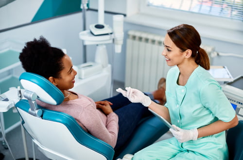 Dentist discussing dental treatment and the Canadian Dental Care Plan (CDCP) with a patient at Mapleridge Dentistry in Vaughan