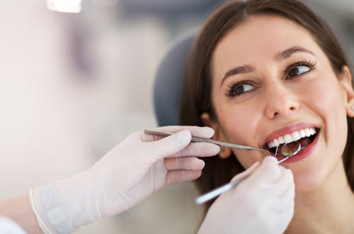 Female patient having a dental exam with a family dentist in the Maple Vaughan clinic