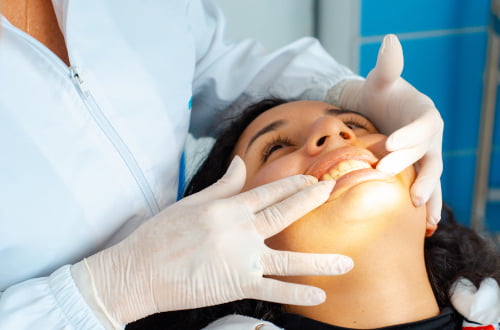Dentist examining patient’s gums during non-surgical gum therapy consultation in Vaughan