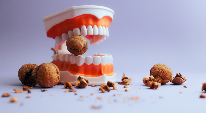 Examples of sticky, hard, sugary, and crunchy foods that damage dental crowns