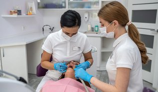 Dentist examining a patient's tooth for signs of a cavity